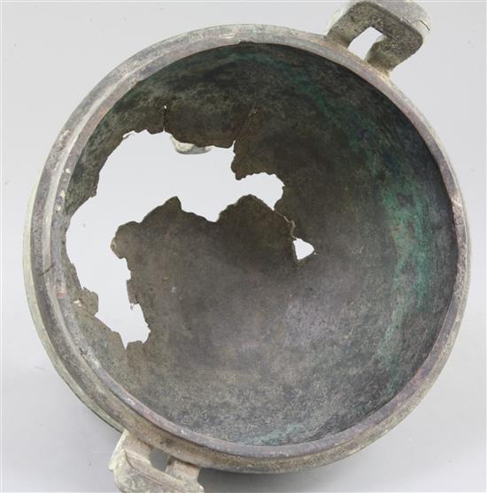 A Chinese archaic bronze tripod ritual food vessel, Ding, Eastern Zhou dynasty, 26.5cm wide, holes to base, cover lacking